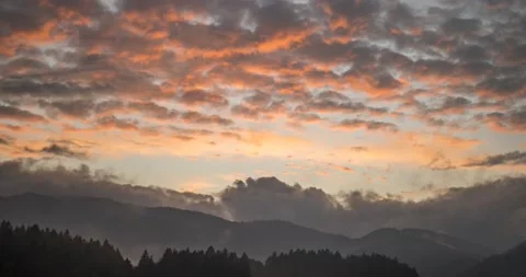 Time lapse view of dramatic sunset. Colorful clouds moving over hills Stock Footage 143827111