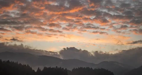 Time lapse view of dramatic sunset. Colorful clouds moving over hills Stock Footage 143827149