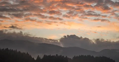 Time lapse view of dramatic sunset. Colorful clouds moving over hills Stock Footage 143827306