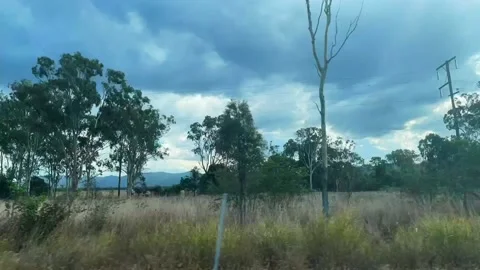 Time-lapse of view driving through outback country side past fields of dry Stock Footage 157420555