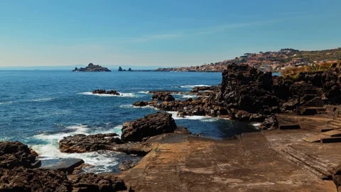 Time lapse view of the faraglioni and the fishing village of Acitrezza in Sicily Stock Footage 110800311