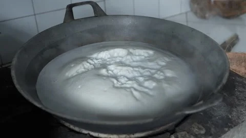 Time-lapse view of foam boiling on a frying pan Stock Footage 261931096