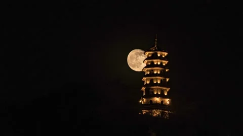 Time-lapse view of the full moon rising behind a pagoda in Liuzhou, Guangxi, Chi Stock Footage 237955761