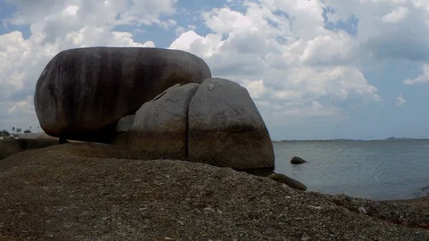 Time-lapse view of a group of big stones on the Tanjung Tinggi beach Stock Footage 101545540