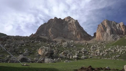 Time lapse view of High Grey Mountain with Background flying clouds Stock Footage 252267018