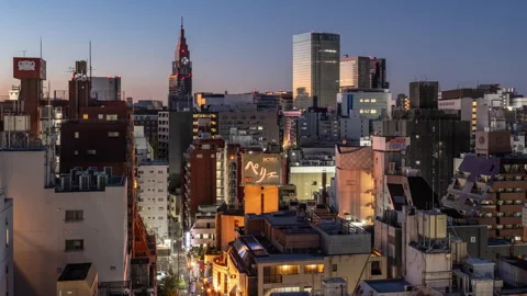 Time lapse view of high-rises in Tokyo, Japan during colorful morning sunrise Stock Footage 295734024