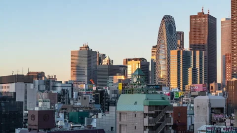 Time lapse view of high-rises in Tokyo, Japan during colorful morning sunrise Stock Footage 295734149