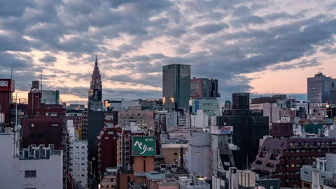 Time lapse view of high-rises in Tokyo, Japan during colorful morning sunrise Stock Footage 295736029