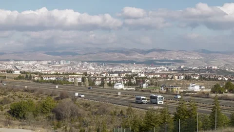 Time-Lapse View Of Highway, City, And Clouds Stock Footage 332346387