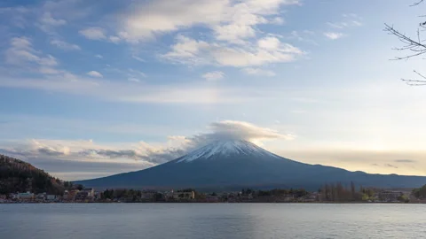 Time lapse view of Mount Fuji during sunset with moving clouds Stock Footage 295735536