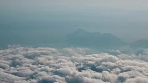 Time lapse View from mountain above clouds against background Island Sea. Moving 스톡 동영상 220373887