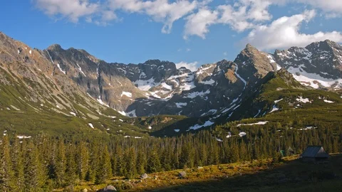 Time lapse view of mountain range party covered with snow and coniferous forest Stock Footage 121551565