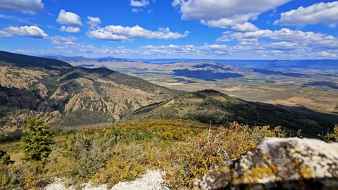 Time lapse-View from mountain top to rural valley-Clouds roll over hills Stock Footage 252098393