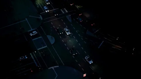 Time lapse view of people and traffic crossing busy intersection at night Stock Footage 85125308
