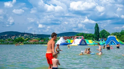Time-lapse view on the people swimming and playing in the Velence lake in Stock Footage 114239658