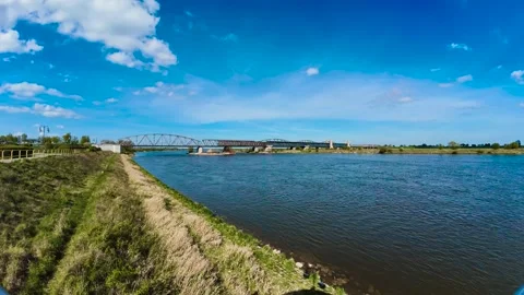 Time lapse view of railway bridge spanning Vistula in Poland. Shifting clouds Stock Footage 313683897