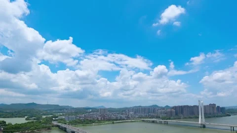 A time-lapse view of a river-crossing bridge in a Chinese city on a sunny day Stock Footage 259681130