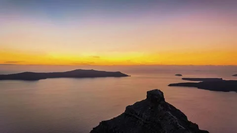 Time-lapse view of Skaros Rock volcanic formation during golden sunset in Stock Footage 346614537