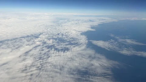 Time-lapse view of the sky with white clouds from an airplane window at high alt Video stock 310441747