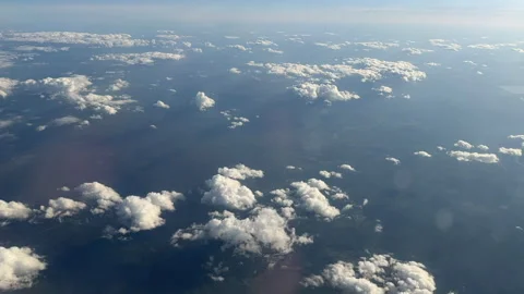 Time-lapse view of the sky with white clouds from an airplane window at high alt Stock Footage 310441802