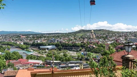 Time-lapse  view on Tbilisi with cable car, ancient church and modern landmarks Stock Footage 76264060