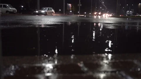 Time lapse view of traffic at night on avenue of cars, in rainy time, puddles. Stock Footage 118201234