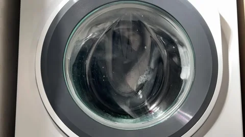 Time-lapse view of a washing machine running a wash cycle, with clothes rot.. Stock-Footage 322215993
