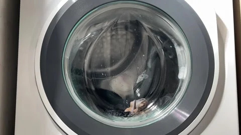 Time-lapse view of a washing machine running a wash cycle, with clothes rot.. Stock Footage 322223162