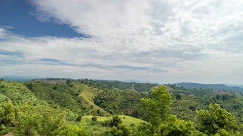 Time lapse view of white clouds moving over the mountain landscape Stock Footage 219545394