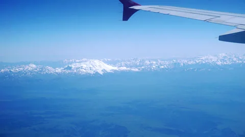 Time lapse: a view of the wing of an airplane flying over the mountains Stock Footage 246877414