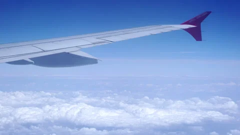 Time lapse: a view of the wing of an airplane flying above the clouds Stock Footage 246879771