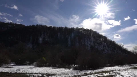 Time lapse view of winter forest with clouds and sun Stock Footage 252957148
