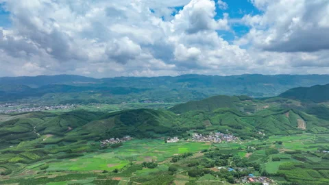 Time Lapse of Village and Rolling Hills with Blue Sky Clouds Stock Footage 320060203