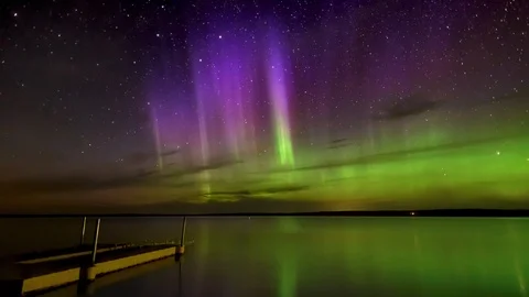 Time lapse of vivid Aurora and stars reflecting calm lake Stock Footage 118384123