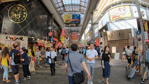 Time lapse walking through crowd in shopping area of Osaka, Japan in Asia Видео 116136521