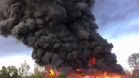 Time lapse of Warehouse engulfed in raging fire with huge column of smoke Stock Footage 78493602