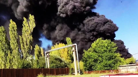Time lapse of Warehouse engulfed in raging fire with huge column of smoke Stock Footage 78493608