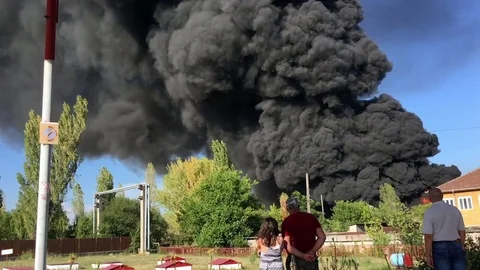Time lapse of Warehouse engulfed in raging fire with huge column of smoke Stock Footage 78493800