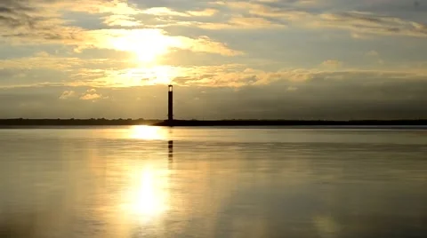 Time lapse of water landscape with lighthouse and clouds at dawn Stock Footage 54540395