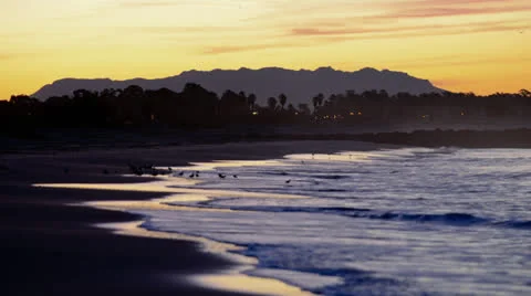 Time lapse of wave breaking along San Buenaventura Beach at sunrise in Ventura, Stock Footage 27188771