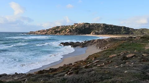 Time lapse of waves crashing into a wild beach Stock Footage 104988375