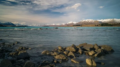 Time lapse of waves washing over a rocky shore at Lake Tekapo in New Zealand Stock Footage 117348340