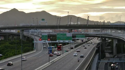 Time-lapse of West Kowloon Highway near Hoi Ying Estate under sunset Stock Footage 233682278