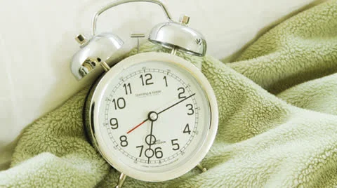 Time lapse of a White alarm clock on blanket Stock Footage 24862621