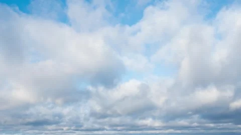 Time lapse of white and dark gray clouds moving in the blue sky on the horizon Stock Footage 292992159