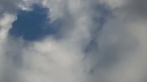 Time lapse of white and grey clouds moving through the sky Stock Footage 139163230