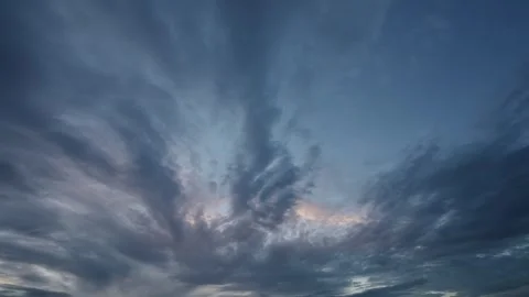Time lapse of white to blueish gray evening clouds moving through a blue sky. Stock Footage 259220391