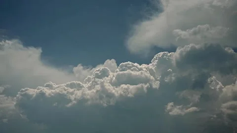  Time lapse of white to blueish grey storm clouds building in a blue sky. Stock Footage 256242823