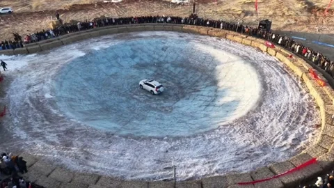 Time-lapse of White Car Stunt Driving in Giant Ice Bowl Stock Footage 329006174