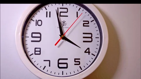 Time-Lapse of a White Circular Wall Clock with a Red Second Hand Stock Footage 337899193